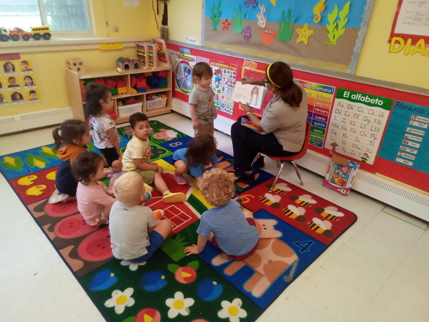 A picture of group of children in a classroom with a teacher